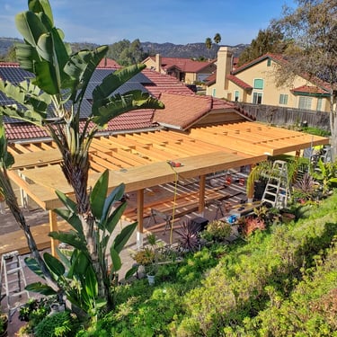 Large wood patio in Escodido with roof sheathing being installed.
