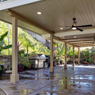 Custom wood patio structure with finished ceilings and electrical for lighting and fans.