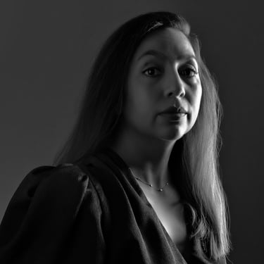 a woman with long hair and a necklace
