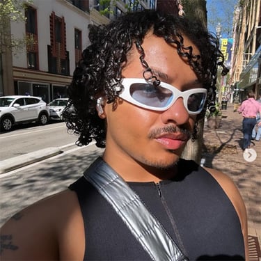 ROJO wearing sunglasses on a city street