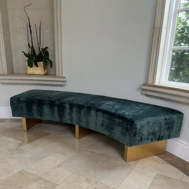 Custom curved bench with emerald green velvet upholstery and gold-painted wooden legs, handcrafted by Solo Home Decor.