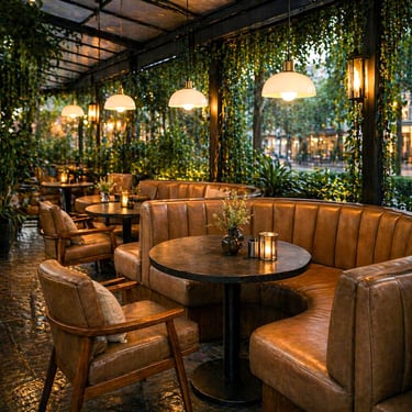 curved leather banquette seating in an upscale restaurant with round tables, lounge chairs, and warm evening lighting