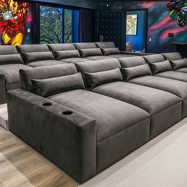 Modern luxury home theater with tiered dark gray velvet seating, cup holders, and plush back cushions by Solo Home Decor.