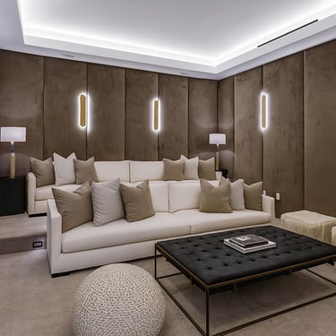 Luxurious home theater with custom wall panels, plush sofa, modern lighting, and stylish coffee table by Solo Home Decor.