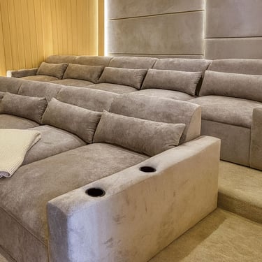 Solo Home Decor custom theater sectional with plush reclined seats, cup holders, and warm lighting