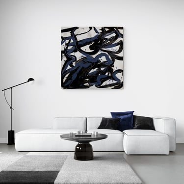 Modern minimalist living room featuring a large abstract blue and black canvas art piece above a white sectional sofa.