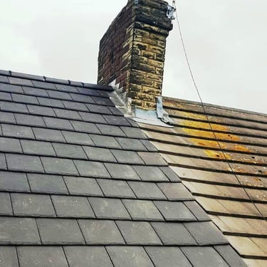 A slate tiled roof replacement showing the difference between new and old