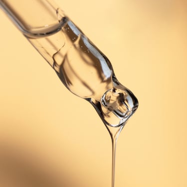 a glass of water with a liquid pouring out of it