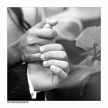 a man and woman holding hands in a black and white photo