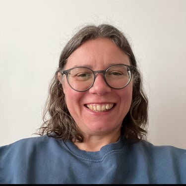 a woman with glasses and a blue shirt