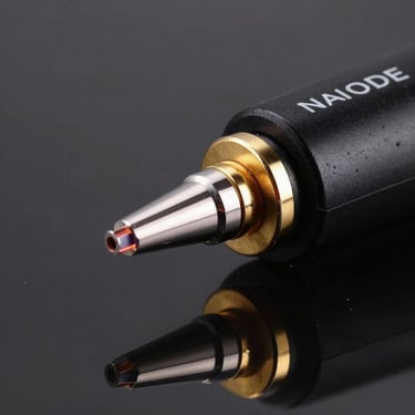 NINEONE PLAMODE device, macro shot of the plasma applicator tip, gold rim light, black glass background