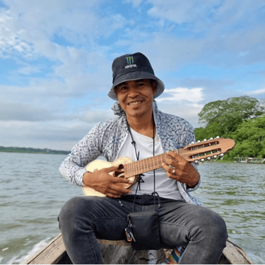 Roger Bardales playing a charango instrument on a boat on the Laguna Yarinacocha.