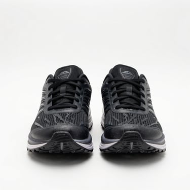 Centered straight-on studio shot of black running shoes on a clean white background, even bright lighting