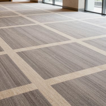 Close-up of luxury low-pile carpet tile in muted warm grey and cream geometric patterns, architectural presentation, 35mm
