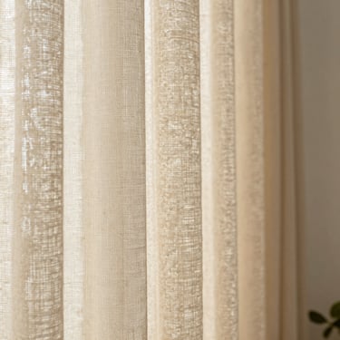 Macro shot of warm beige organic linen curtain fabric, daylight catching the rich weave texture, high-end editorial, 35mm
