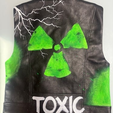 Gilet nero in pelle con sfumature verdi e scritta Toxic bianca vista frontale