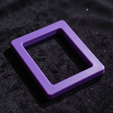 Close-up of thick sacred purple acetate frame catching low architectural light, casting a deep shadow on a dark velvet surface.