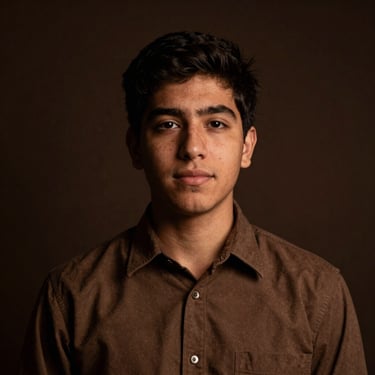 Warm editorial portrait of Mateo, a Chilean theology student, soft low-key directional lighting, dark espresso background, 35mm photography