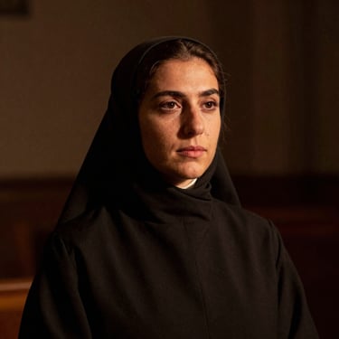 Warm editorial portrait of Sofia, a Spanish catechist, warm chiaroscuro lighting, subtle sepia tones, dark academic background, 35mm photography