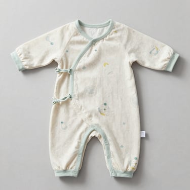 Clean flat-lay of organic cotton babywear, soft pastel tones, natural daylight.