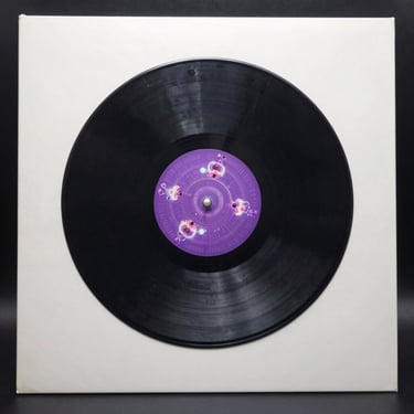 Square close-up of a double gatefold vinyl record sleeve with a glowing purple reactor core graphic.