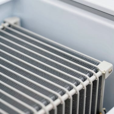 Macro shot of a clean refrigerator condenser coil, bright utility lighting