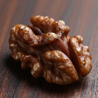 Macro shot of dark oiled walnut grain, smooth matte finish, soft natural light reflecting off the wood surface.