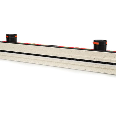 ERGOVENT LINEO PRO single-slot angled view showing gypsum body with black slot grille and two round duct inlets