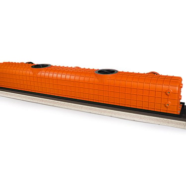 ERGOVENT LINEO PRO PUZZLE top angled view showing orange plenum body with round duct inlets and gray gypsum base