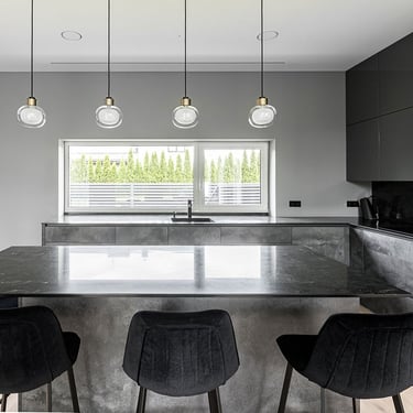 Luxury kitchen island with ERGOVENT RONDO diffusers flush-mounted invisibly in white ceiling above dark cabinetry.