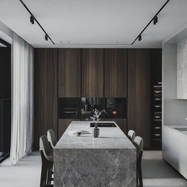 Luxury kitchen with ERGOVENT KVADRO diffusers flush-mounted in ceiling above marble island and dark wood cabinetry.