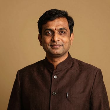 Dignified professional portrait of a South Asian community leader, warm golden hour light, rich deep tones, 35mm