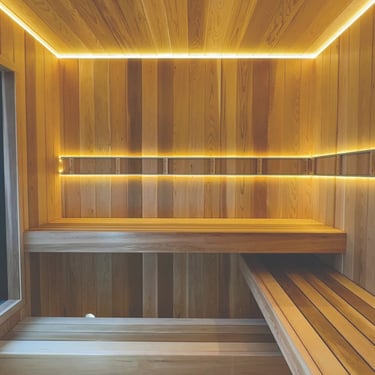 Cedar sauna interior with modern LED strip lighting built in Scandinavian style for Ontario homes