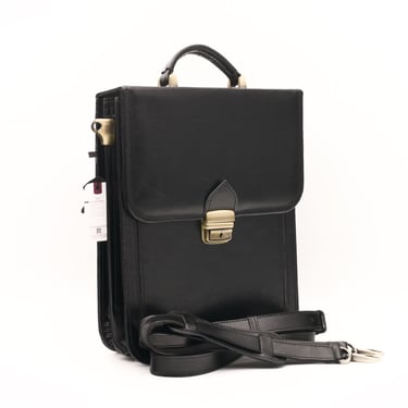 Geantă din piele neagră, fotografiată din lateral, pe fundal alb.