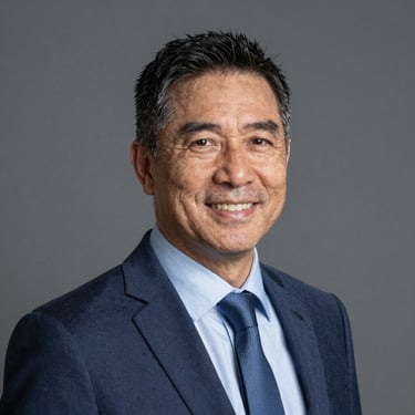 A smiling professional man in a modern office setting, representing James Walker.