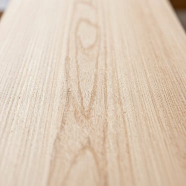 Extreme close-up macro detail of raw white oak timber grain, bright natural daylight, shallow depth of field