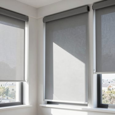 Detail architectural shot of a modern bedroom window with a premium grey blackout roller blind completely blocking the afternoon sun, high-contrast, 35mm