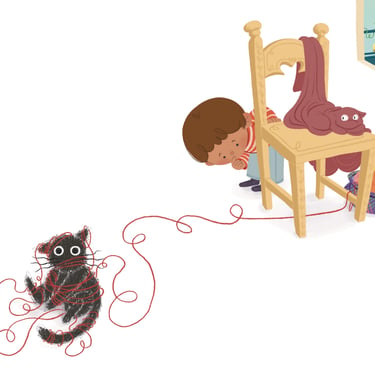 niño con gatos haciendo travesuras con el estambre