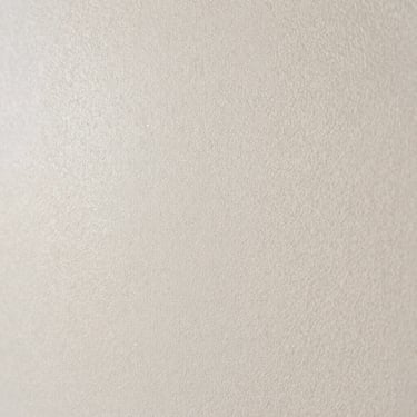 Macro shot of a seamless drywall patch, perfectly sanded and smooth under bright natural daylight