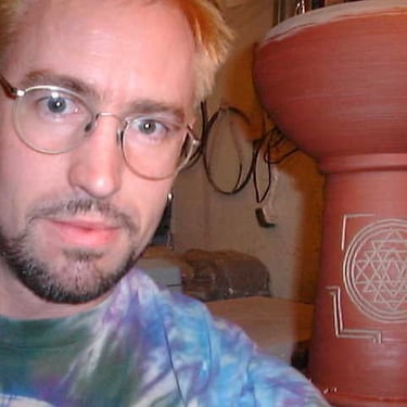 Patrick Brumm with hand made ceramic hand drum (dumbek) with Shri Yantra carving