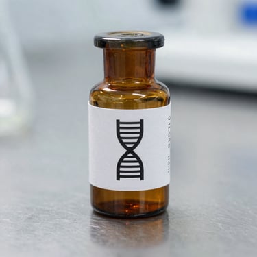 Amber glass research vial with a clean technical label showing a precise DNA-helix icon, resting on a sterile metal laboratory surface, sharp focus.