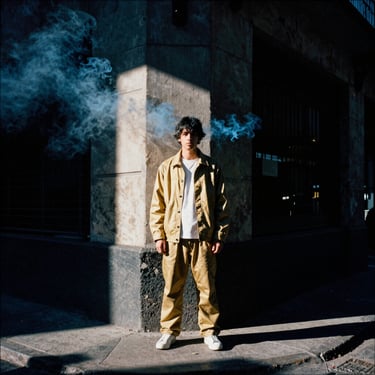Gritty night scene of a street corner in Buenos Aires with blue smoke flares, high-contrast direct sunlight, 35mm film grain.