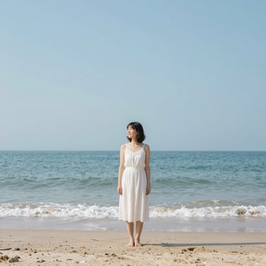 a lady standing at the beach