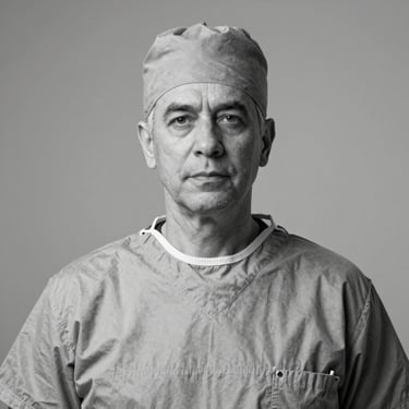 Professional black and white studio portrait of a senior male plastic surgeon in clinical attire, neutral background, objective framing.