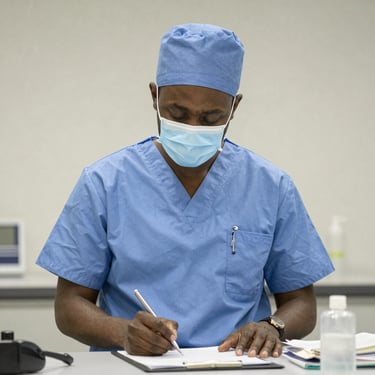 A smiling healthcare professional reviewing AI-generated patient data on a tablet in a bright clinic.
