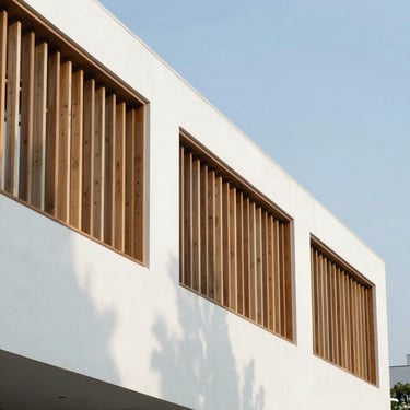 Geometric architectural exterior with clean white volumes and wooden louvers, sharp linear shadows, bright clear sky