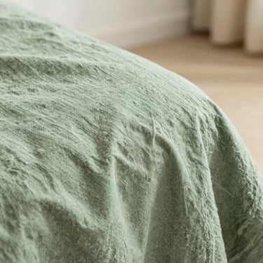 Close-up of high-quality fabric texture, soft sage green linen weave, natural lighting