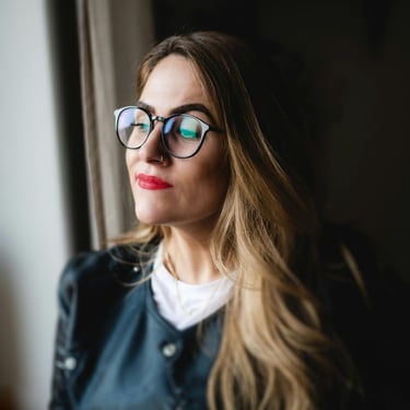 Frau um die 45 steht  entspannt am Fenster