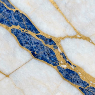 Macro photograph of premium white and gold Arabescato marble slab texture, polished surface reflecting light, 35mm