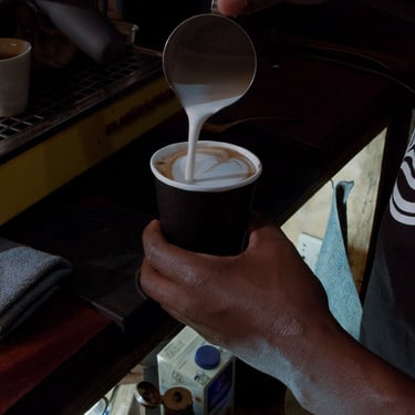 Milk being poured into a latte in the poetry short film Nothing.